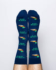 Pair of blue socks with green text and designs on a light gray background