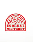 Embroidered patch with pizza design and 'In Crust We Trust' text on a white background