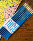Set of blue pencils with a clear plastic case on a map background