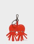 Red heart-shaped keychain with a unique design on a white background