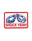 Embroidered patch with oysters and 'SHUCK YEAH' text on a white background