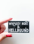 Patch with 'Whiskey Bent & Hellbound' text held by a hand on a white background