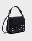 Black handbag with eye-shaped studs on a light gray background
