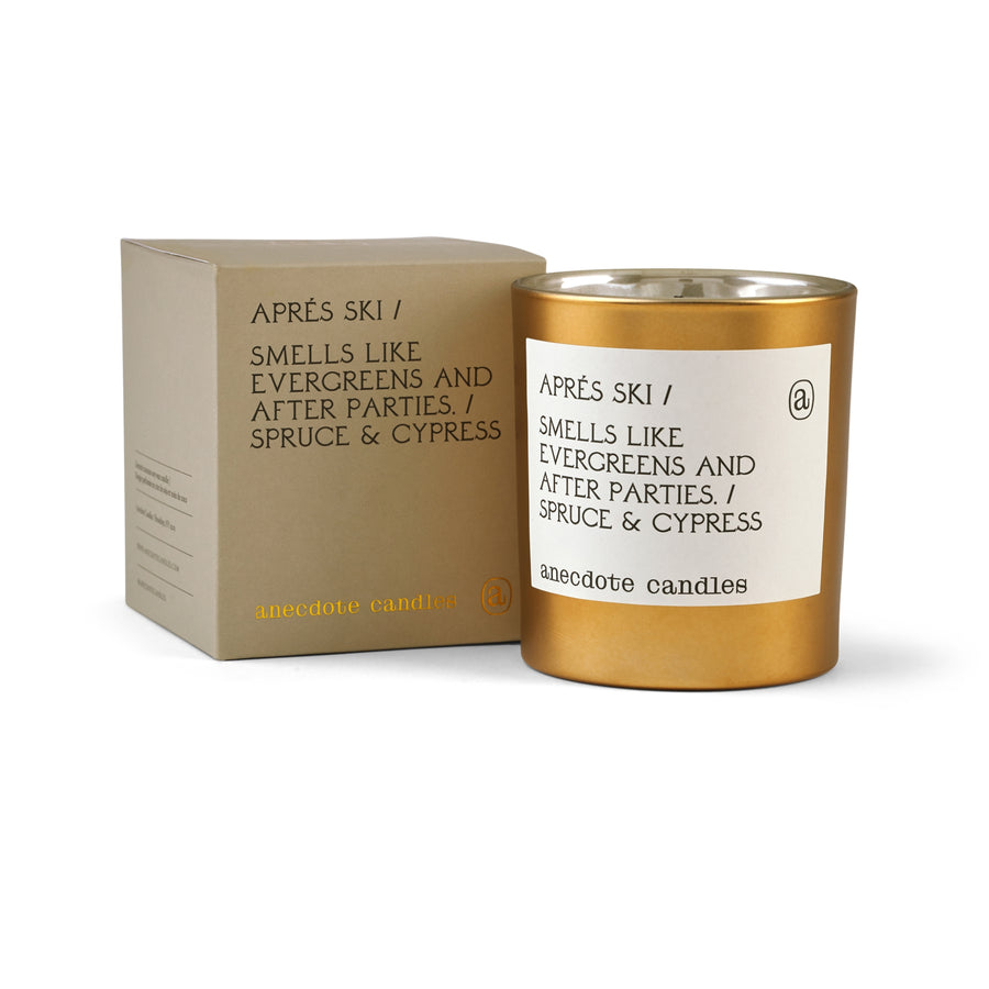 Gold candle and packaging with 'anecdote candles' branding on a white background