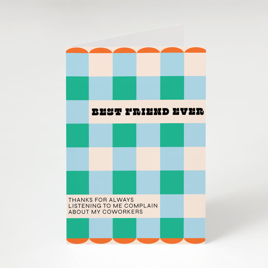 Notebook with a colorful checkered pattern and text on a white background