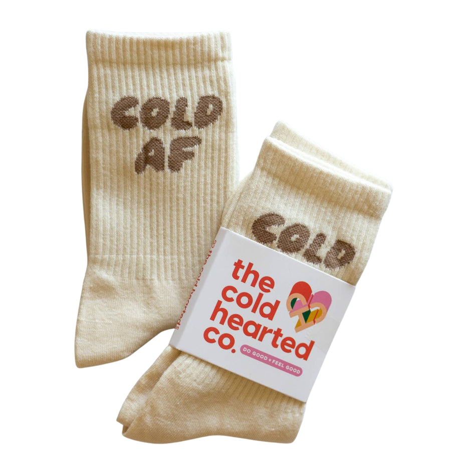 Beige socks with 'COLD AF' text and a branded label on a white background