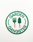 Circular patch with 'Garden Gangster' text and gardening tools on a white background