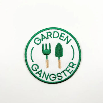 Circular patch with 'Garden Gangster' text and gardening tools on a white background