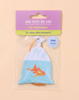 Air freshener with goldfish design in packaging on a beige background