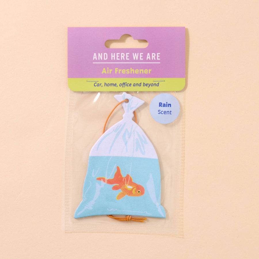 Air freshener with goldfish design in packaging on a beige background