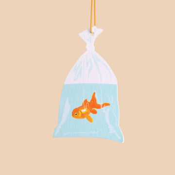 Plush toy of a goldfish in a bag on a beige background