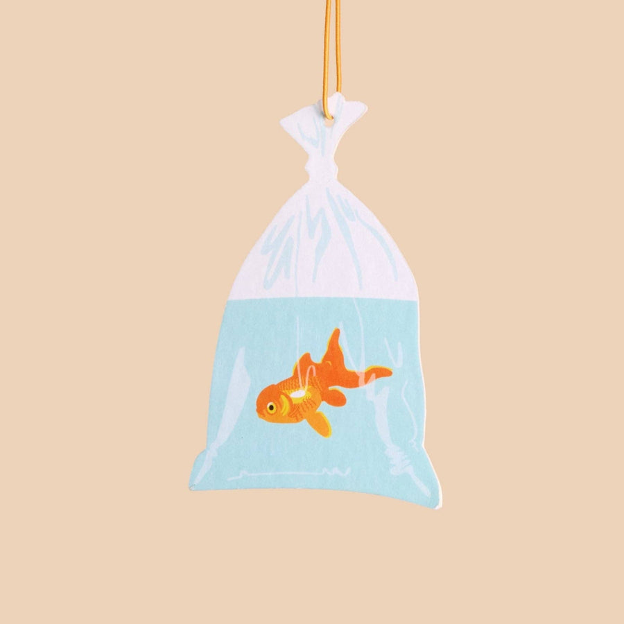 Plush toy of a goldfish in a bag on a beige background
