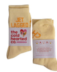 Beige socks with 'the cold hearted co.' label on a white background