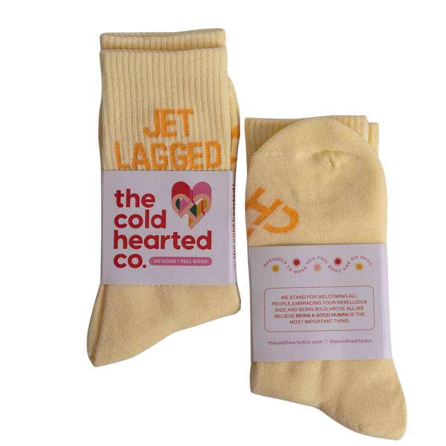 Beige socks with 'the cold hearted co.' label on a white background