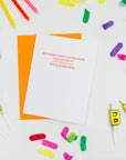Birthday card with colorful candles and confetti on a white background