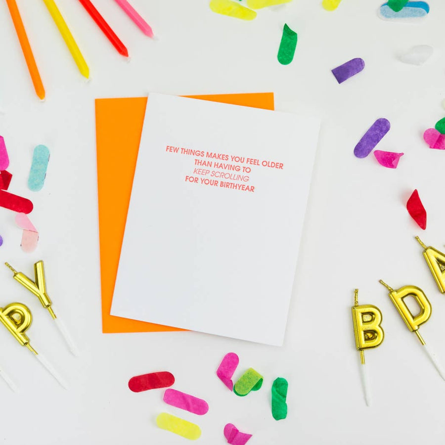 Birthday card with colorful candles and confetti on a white background