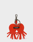Red heart-shaped keychain with a black tag on a white background