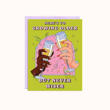 Greeting card with illustration of hands holding drinks and text 'Here's to growing older but never wiser' on a green background.