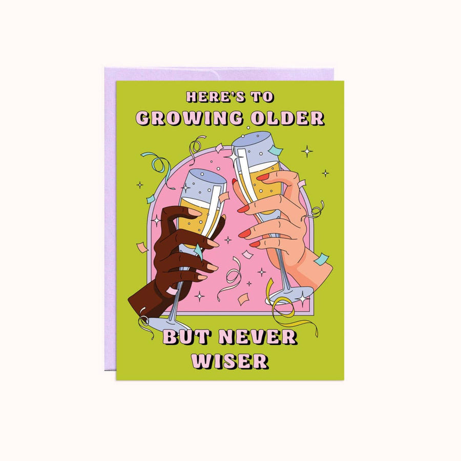 Greeting card with illustration of hands holding drinks and text 'Here's to growing older but never wiser' on a green background.
