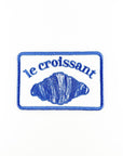 Embroidered patch with 'le croissant' text and croissant illustration on a white background