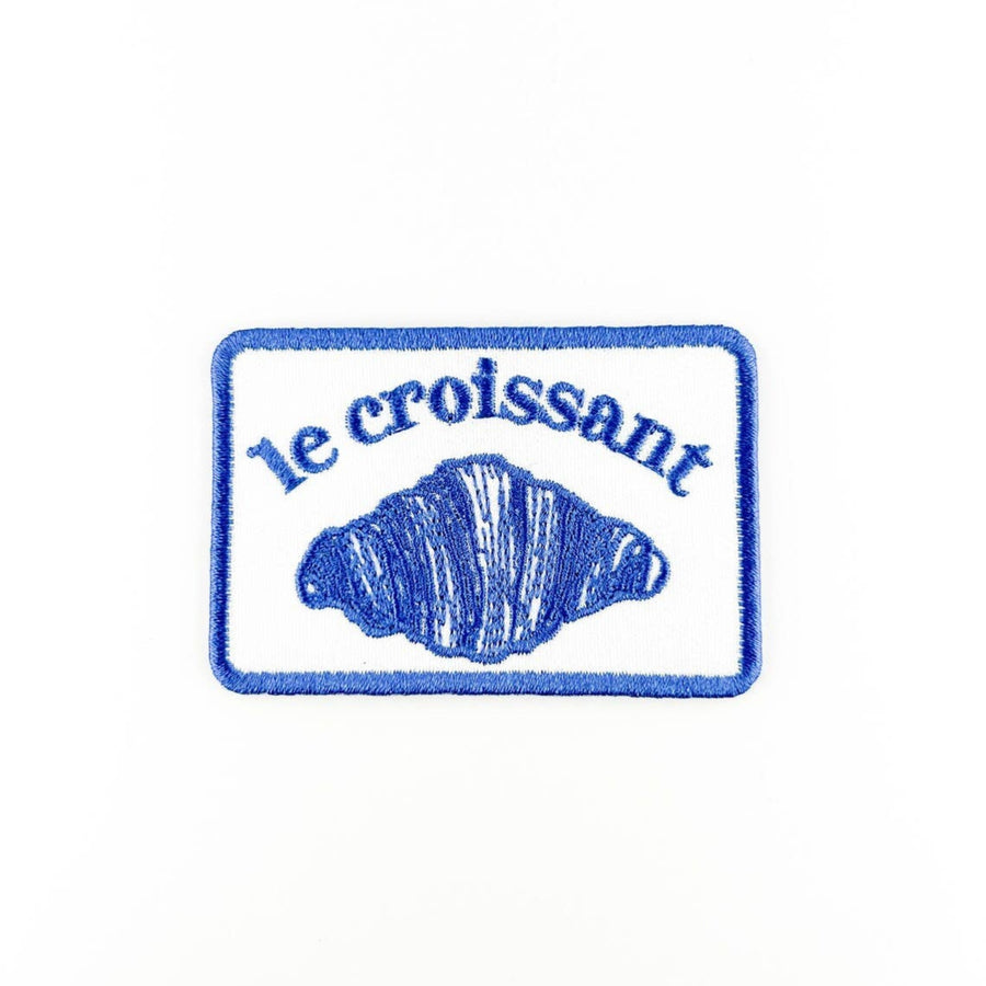 Embroidered patch with 'le croissant' text and croissant illustration on a white background
