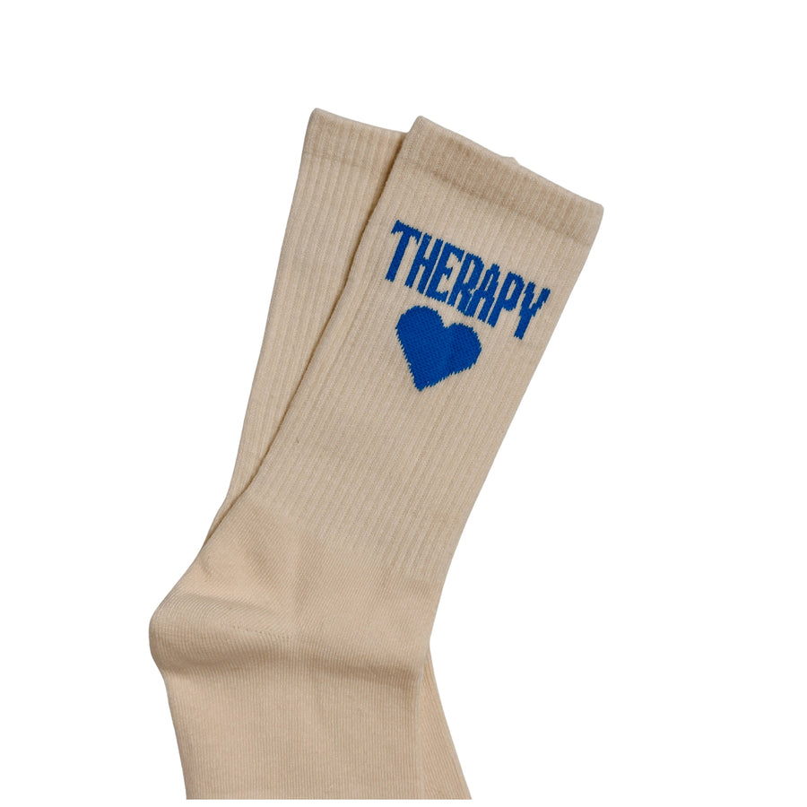 Beige socks with blue 'HEART' and 'THERAPY' text on a white background