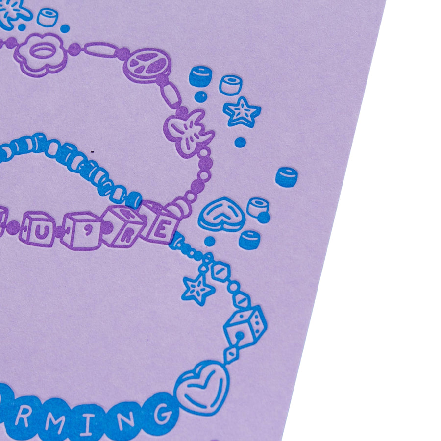 Purple and blue jewelry design on a purple background