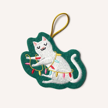 Embroidered cat ornament with Christmas lights on a green leaf-shaped background